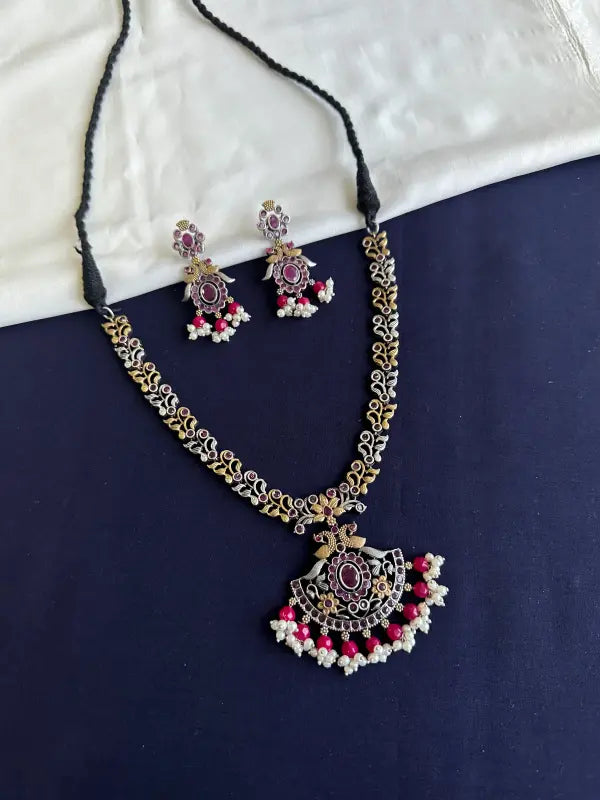 Handcrafted Shiny Dual-Tone Magenta Necklace with Brass, German Silver & Semi-Precious Stones
-Regular Necklace Sets