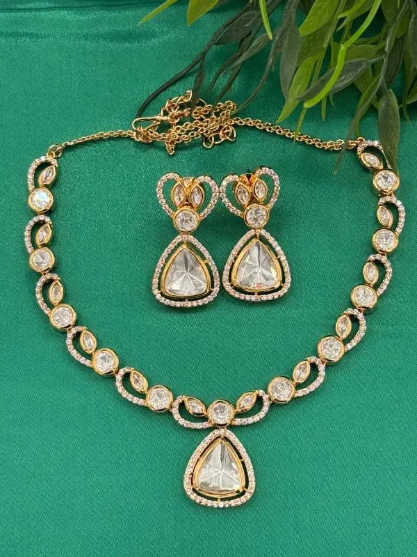 Handcrafted Kundan Jewelry with White Cubic Zirconia and Glass Stone – Golden-Tone Elegance
- Necklace Set